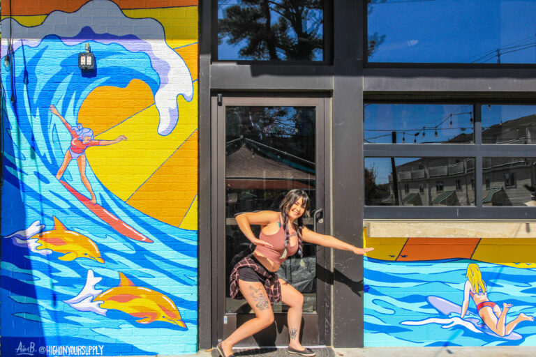 Aimee, in front of her award winning mural at Vibrant Shore Brewing on 18th St.
